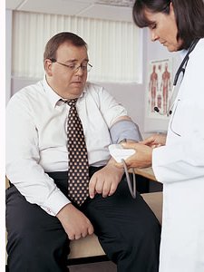 Doctor taking mans blood pressure